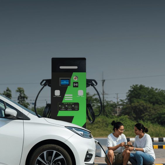 woman charging her electric vehicle at a highway EV charging station
